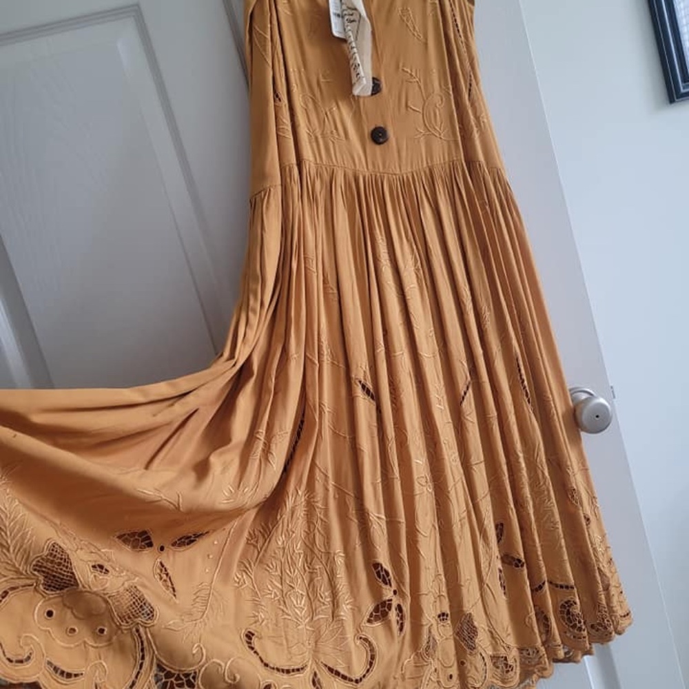 Never worn ..Peasant Dress by Free People...It is calling YOUR name.